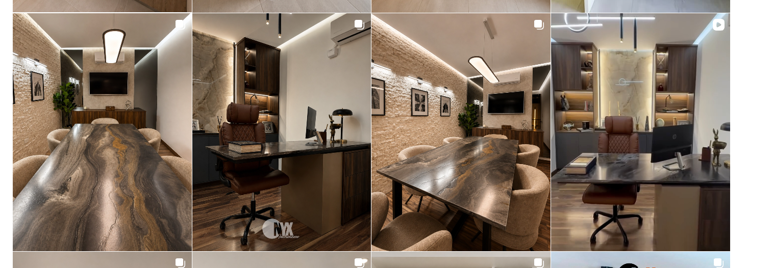 Sala de juntas con mesa de piedra y diseño de iluminación